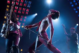 Queen band members Brian May, Freddie Mercury, and John Deacon  
(from left to right) performing on stage during a show.  Photo courtesy of The New York Times.