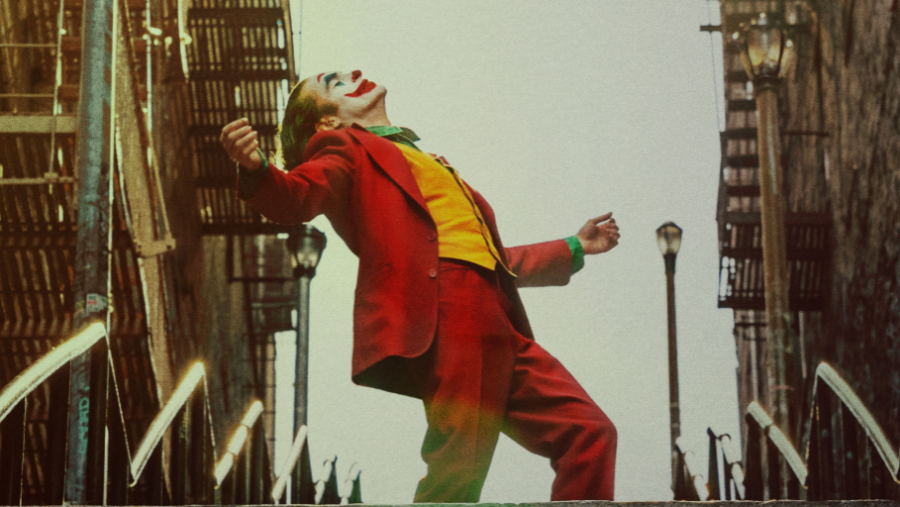 The+Joker+standing+atop+of+cement+stairs+in+Gotham+City.++Photo+courtesy+of+the+official+Joker+movie+website.+