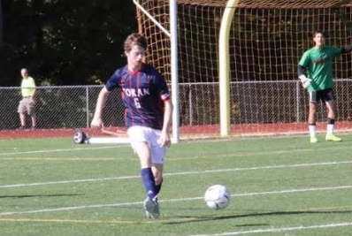  Senior and captain, Brendan May, carries the ball through the defensive zone earlier this month. Photo courtesy Lucila Massey.