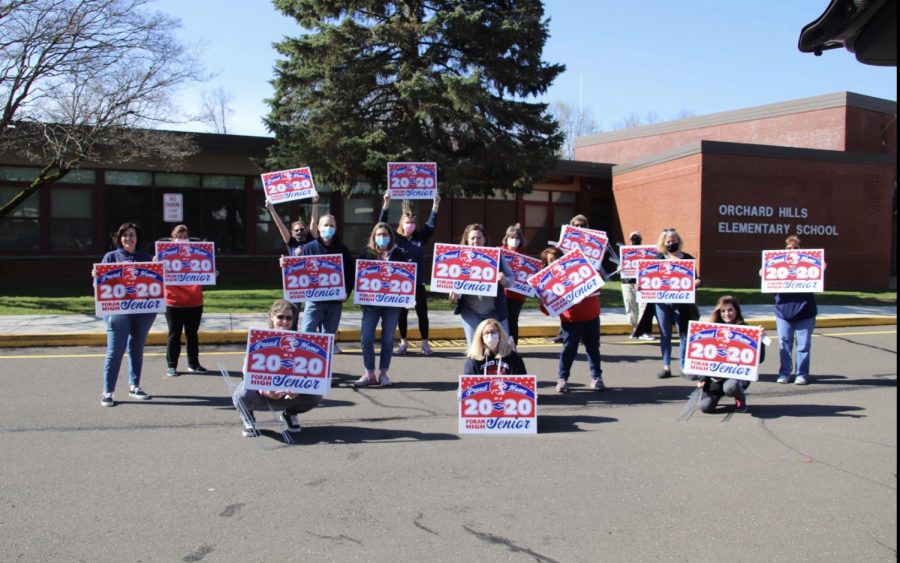 Parent volunteers pose before heading out to place signs in senior’s yards. Photo courtesy of Corina Massey. 
