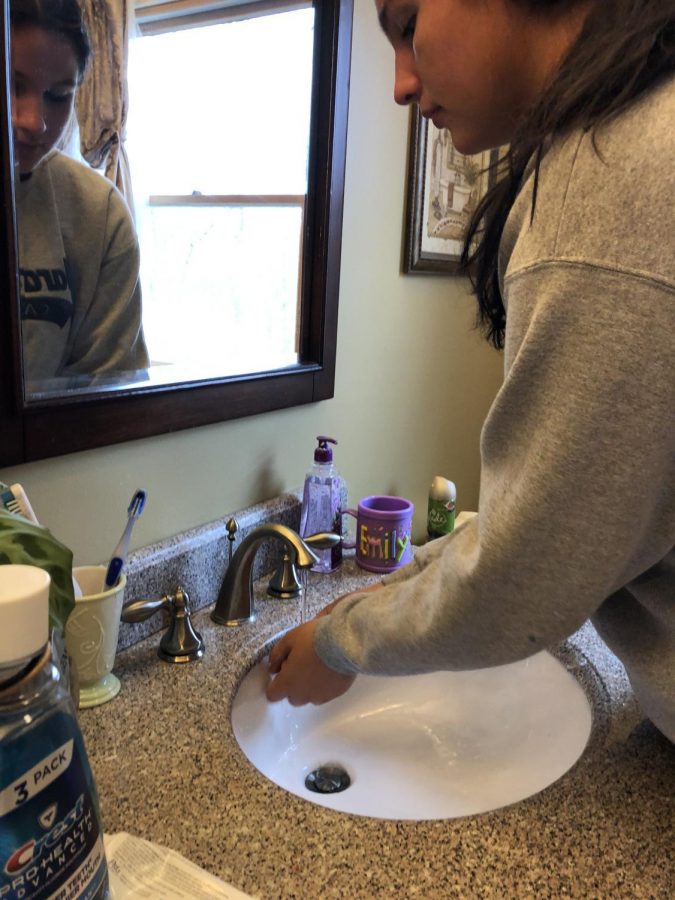Junior Emily Eschweiler practices washing her hands for 20 seconds in order to prevent the spread of the coronavirus disease.