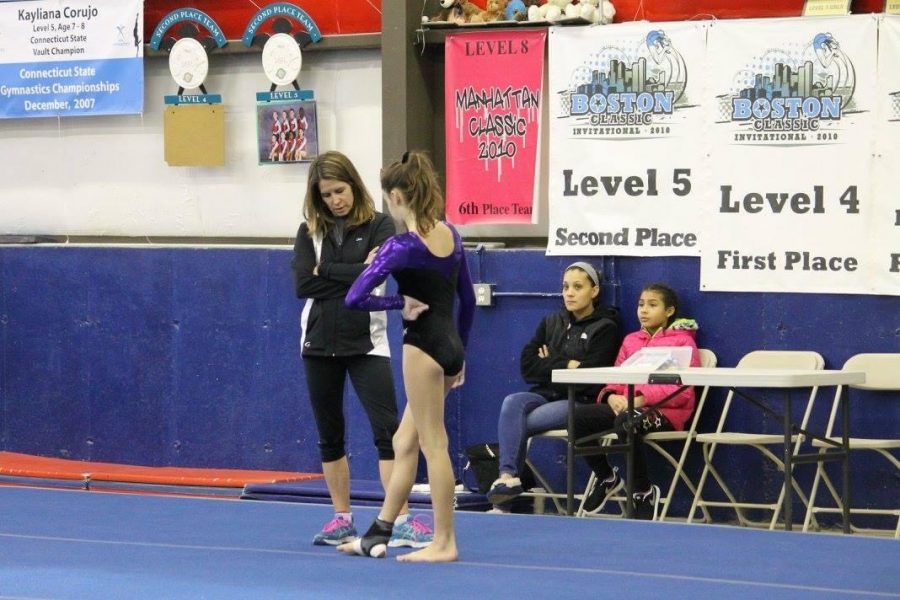 Coach Lisa Dodge of Polly’s at a meet with one of her gymnasts.
 Photo Courtesy:  Samantha Lambert, January 2016