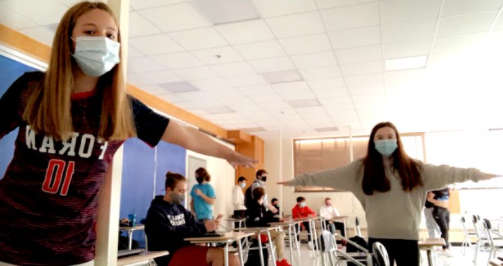 Freshman Pia Delcegno (on left) and Kelsey Kiely (on right) social distancing and wearing their masks during the first week of school. 
Photo Courtesy: Pia Delcegno
