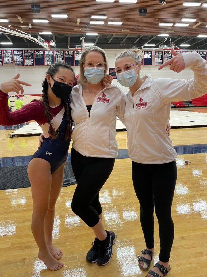 
Riley Grunow, Kyra Umbreit, and Ginger Schmidt posing for a photo at a meet. Photo Courtesy: Shea Carrol, January 2021.