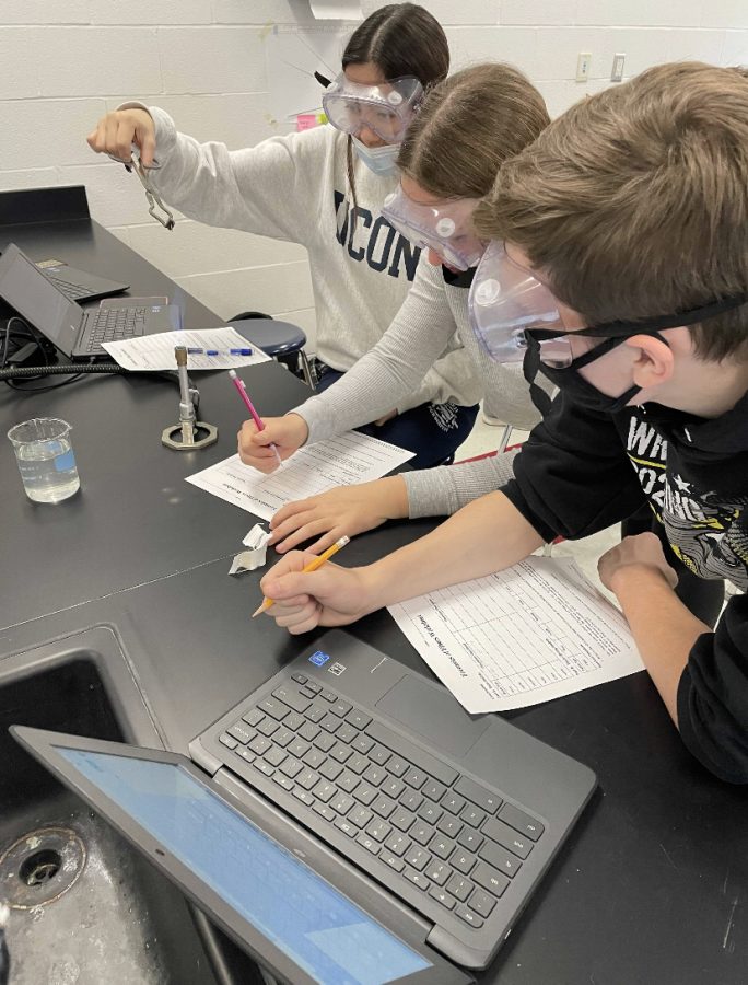 Firing Fiber: Three students in Mr. Sember’s Forensics class complete a lab on Fiber Analysis.