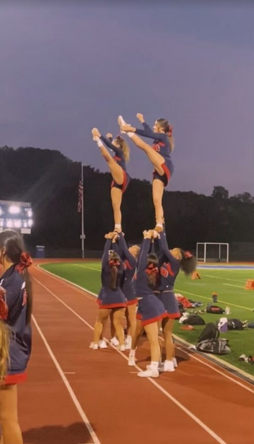 Flying High: Flyers Anna Paul and Luci Cappello perform at the Foran vs Brookfield football game. Photo Courtesy: Meghan Oliver, September 24, 2021.