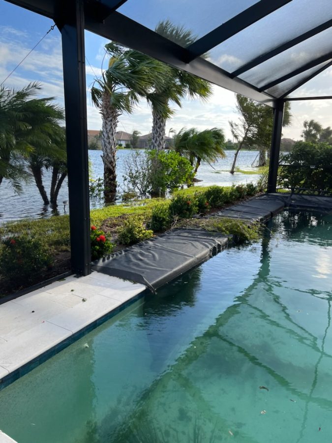 Screen Damage: A section of the screen in this lanai laying in a backyard pool in IslandWalk at the West Villages in Venice, FL. October 7, 2022.