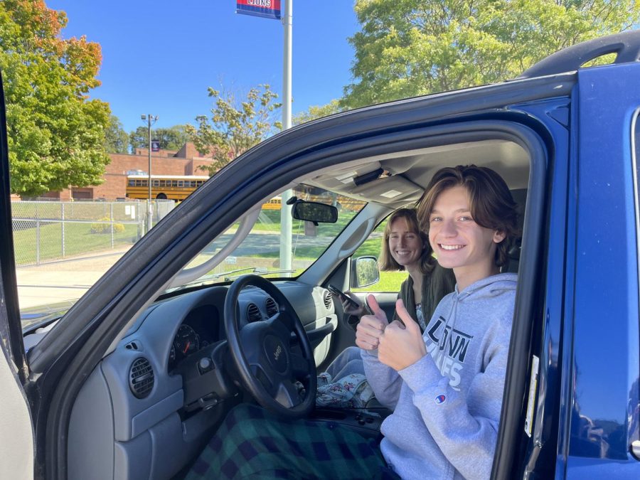 Behind the Wheel: Senior Tighe Duggan poses in his car with Anna Harris in the passenger seat, September 23rd, 2022. 