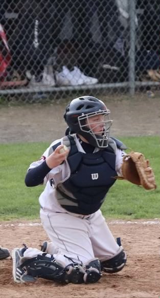 Stopping a Steal: Brendan Fallon prepares to throw the ball as a runner attempts to steal a base, April 16, 2022.