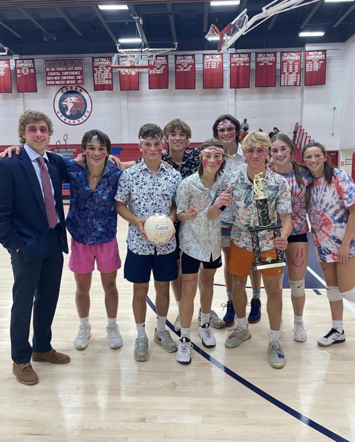 Your 2022 Play For a Paws Champions: Boys soccer stands with their championship trophy from their charity volleyball game victory, November 17, 2022. 