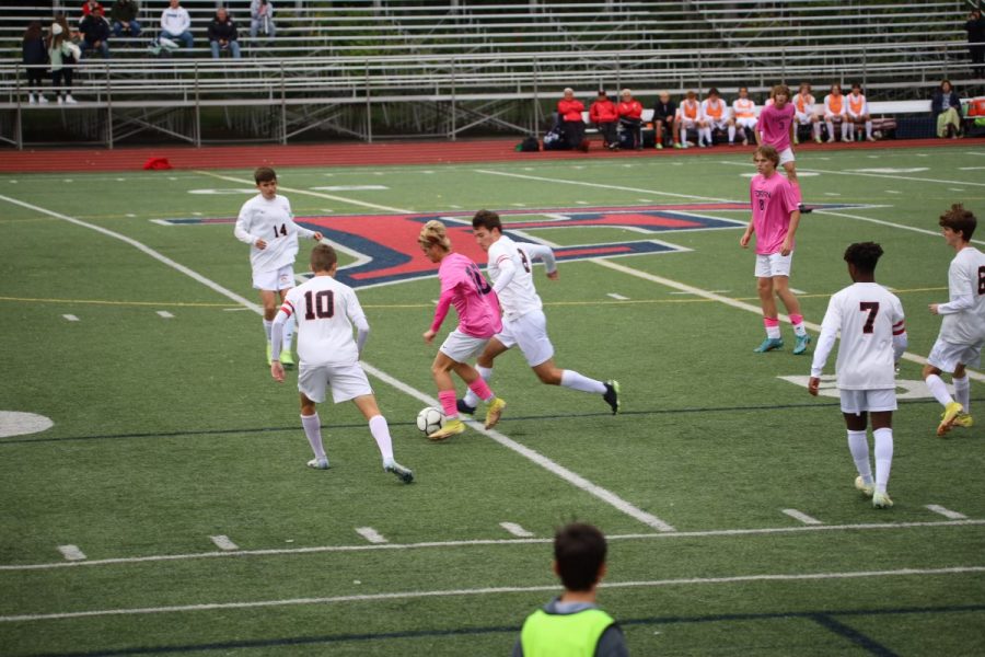 A Civilized Game: Senior Cristian Boutote dribbles with Cheshire defenders surrounding him, October 3, 2022. 