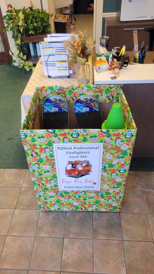 Charity Collection: Milford Fire Department Displays Toys for Tots donation box downtown. November 16, 2022.