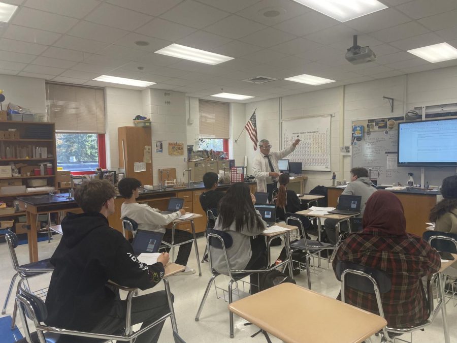 Up and Atom: Sophomores in Chemistry and the Earth Systems watch as Mr. Connors explains a reaction, November 9, 2022.