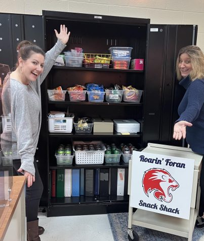 Snack Stash: Ms. Kaminski, left, and Ms. Bourque show off the cabinet filled with snacks ready to fill orders for the Roarin’ Foran Snack Shack, March 13, 2023. 