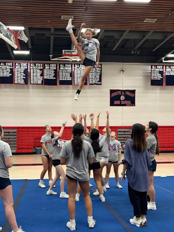 Soaring Through Stunts: Foran’s cheer team perfecting their stunts in preparation for competition. 