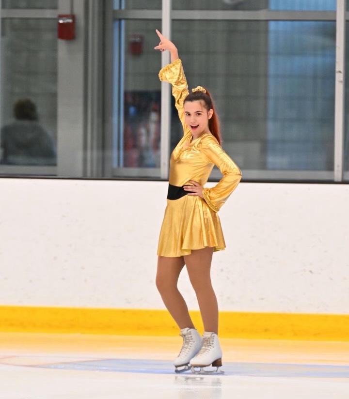 Glittering in Gold: Adrianne Shields poses solo on the ice. 