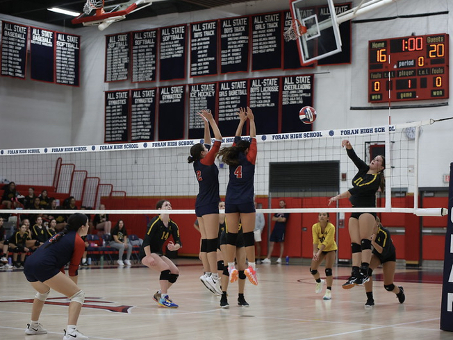 Defense Wins Championships: Foran Volleyball players Nyah Boromei and Aubrey Pippa attempt to block a spike in the Edna L. Fraser Gymnasium. September 20, 2023.