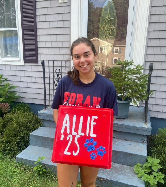 Cheer Season: Allison Stefan posing for the camera with crate she decorated for cheer, August 20, 2023.