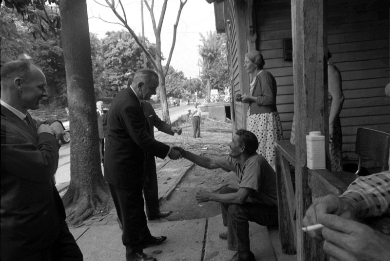 War on Poverty: President Lyndon B. Johnson meets with an American struggling with poverty, 1964. 