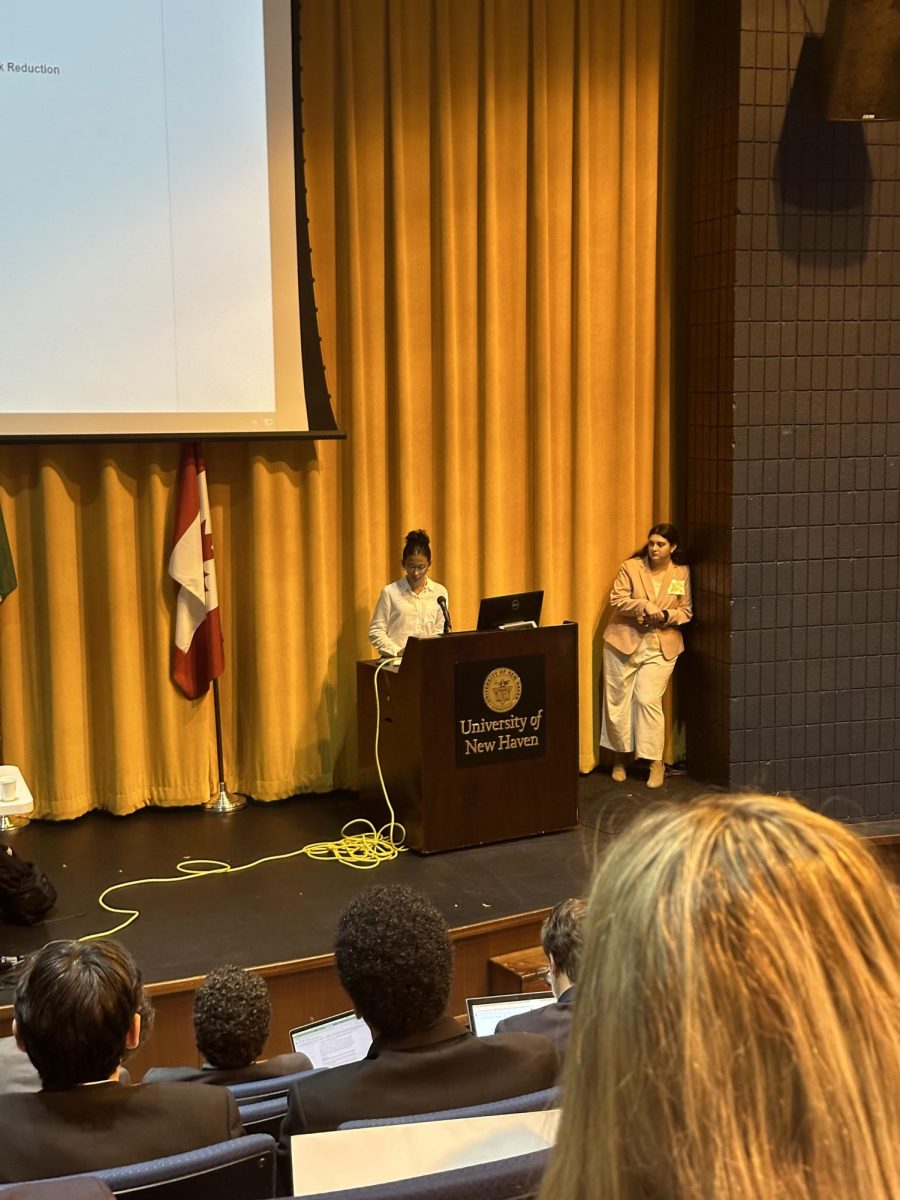 At the Podium: Senior and MUN club officer Allie Regan speaks at the ChargerMUN conference. October 2023. Photo by: Dabi Lee.