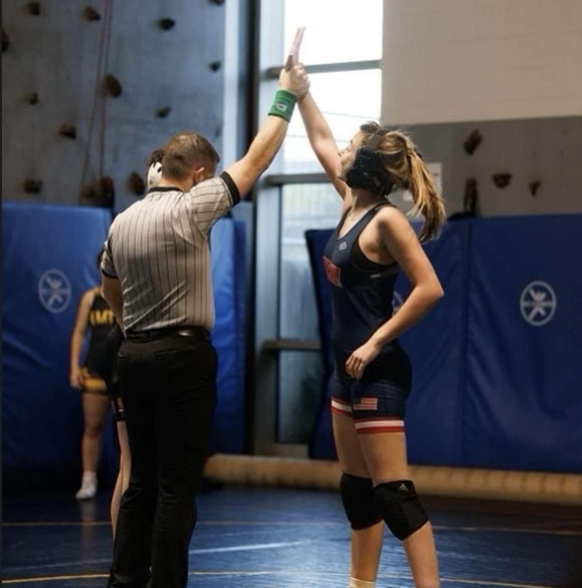 Serefina Pavlat getting her hand raised after a hard-fought victory, Jan. 2023.
