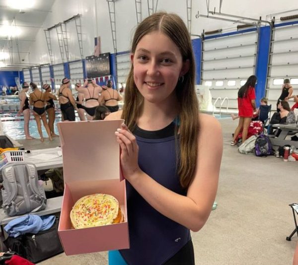 Sweet Moments, One Crumb At A Time: Senior Lila Rothbard holding the Celebration Crumbl cake that the Foran girl's swim team enjoyed on her birthday, October 28, 2024. Photo by: Lexi Wainman