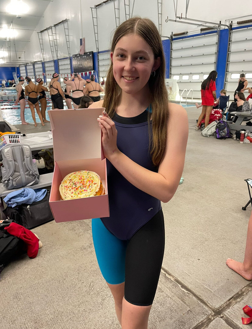 Sweet Moments, One Crumb At A Time: Senior Lila Rothbard holding the Celebration Crumbl cake that the Foran girl's swim team enjoyed on her birthday, October 28, 2024. Photo by: Lexi Wainman