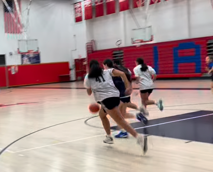 Work Hard, Play Harder: Players on the girl’s basketball team scrimmage during practice, December 5, 2024. Photo Courtesy: Foran Girls Basketball