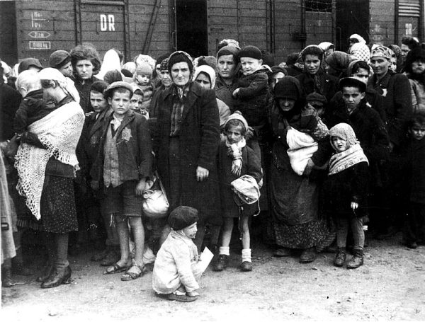 Selection at Auschwitz:. The Jewish people arriving at Auschwitz are lined up on the selection ramp by Nazi officials. May, 1944. Photo courtesy: Bundesarchiv