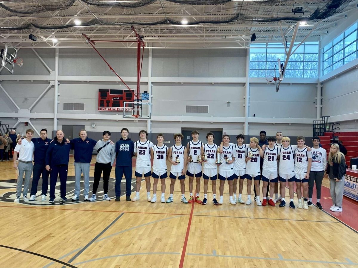 Foran Three-Peats: Foran lines up to take a photo after defeating Sheehan in the Christmas tournament championship and named the reigning champions.