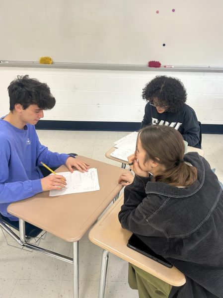 Fueling Curiosity: Mrs. Blanchard helping two students, Junior Joseph Meade and Senior Ava Jaquez-Munroe with pre-calc.