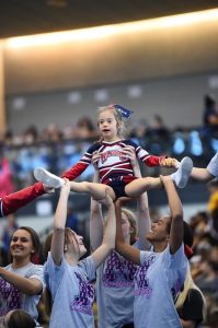 Ava up in a stunt, photo provided by: Southern Connecticut Pop Warner