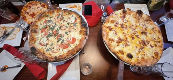 “This Pizza is Fire!”: Fire Engine Pizza Co.’s loaded mashed potato pizza and mozzarella margherita pizza. Photo Courtesy: Caroline Kidahl-Olmeda. March 29, 2025. 