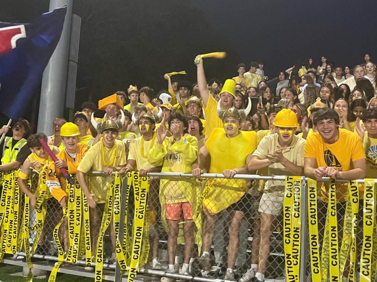 Caution: Fans in the student section pose for a picture
while wearing yellow to support childhood cancer awareness.
September 26, 2025. Photo courtesy: Lisa Farrell.