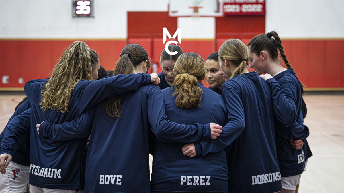 Game Ready: The Girls Basketball team in a last-minute huddle before the game starts, December 28, 2024. Photo Courtesy: Addi Mangosing.