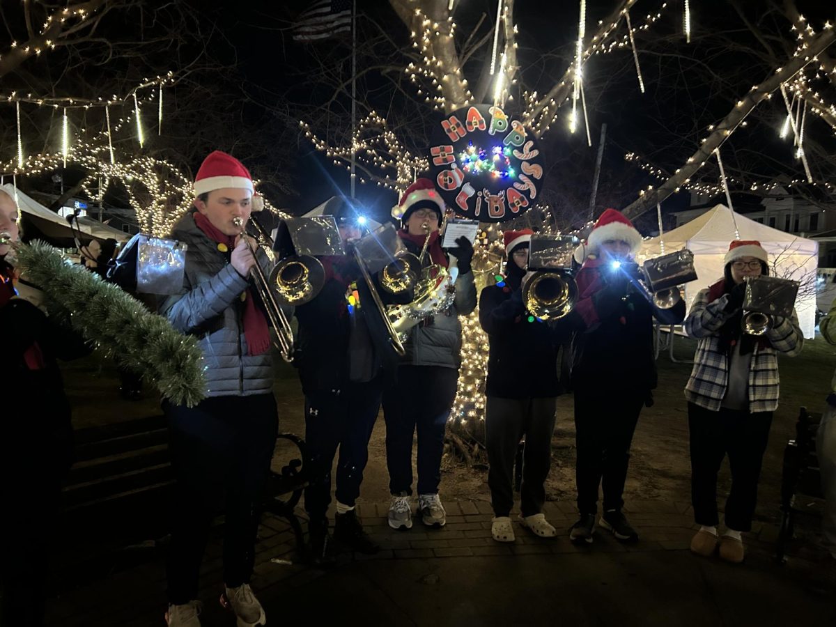 Soundtrack to the Night: The Foran Band brass section playing during the Lamplight Stroll, December 6, 2024. Photo Courtesy: Jessica Turner.