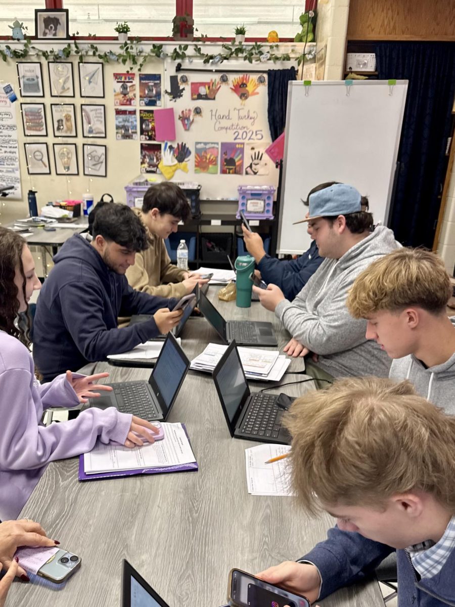 Tech in Class: Miss Green’s Senior English Class, distracted by their phones. DISCLAIMER: This is a staged photo and does not reflect the expectations set and enforced by Miss Green, December 9, 2025. Photo courtesy: Gianna Bellon.