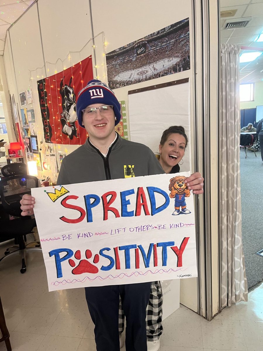 Spreading Pawsitivity: Senior, Joseph Kerzner, supporting optimism with an awareness poster, February 9, 2026. Photo courtesy: Jack Henkel. 