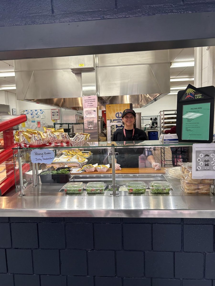 The Deli Line: A cafeteria worker at the deli line preparing for the incoming lunch wave, February 9, 2026. Photo courtesy: Leila Botonjic.