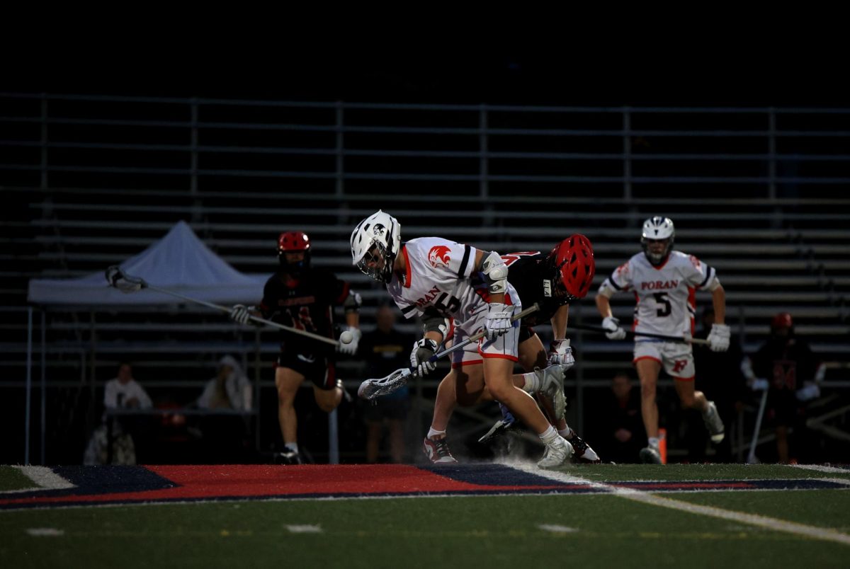 Face Off: Senior Shane Trevethan wins the face off in an intense game versus Branford, May 8, 2025. Photo Courtesy Maria Crocco.