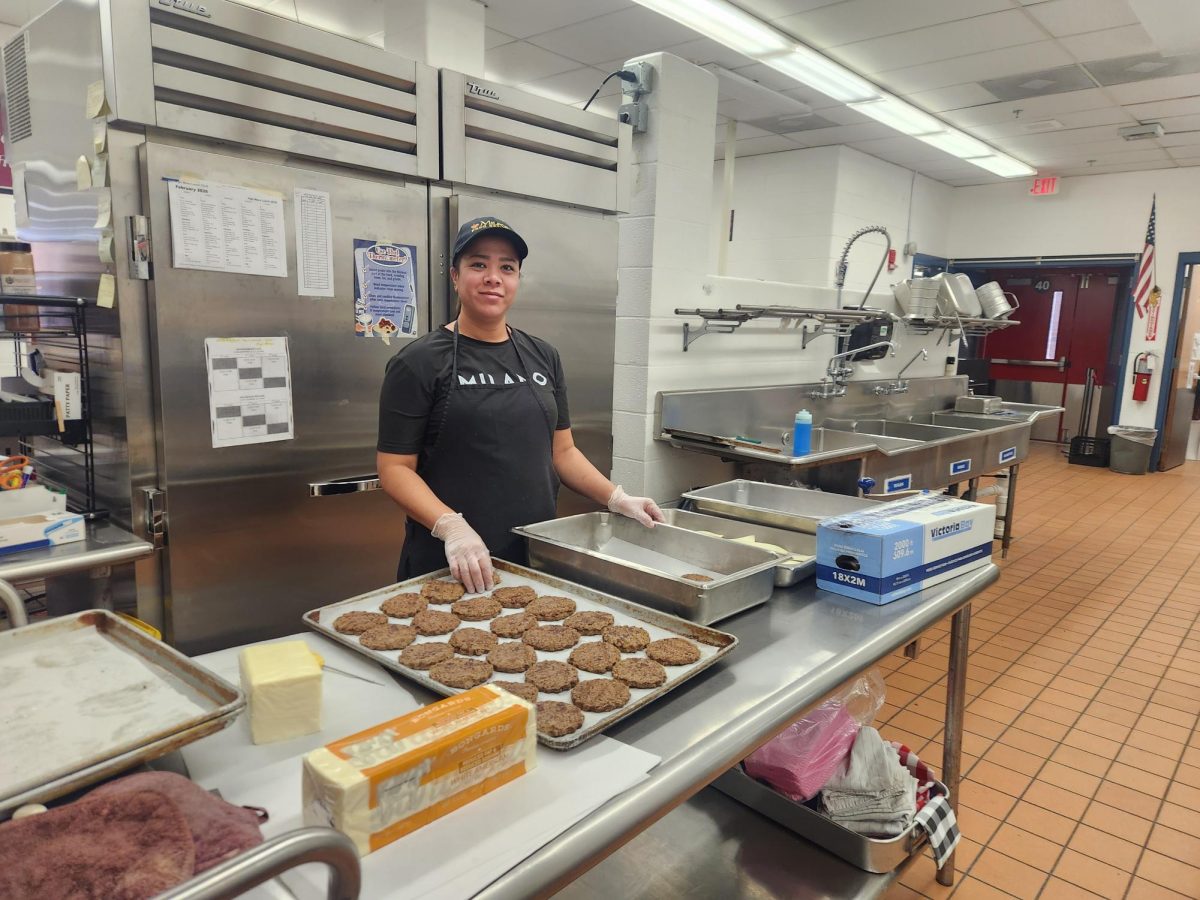 Preparing: Ms. Chow Yen standing next to the food prepared for that day’s lunch, February 4, 2026, Photo courtesy: Madeline Babcock