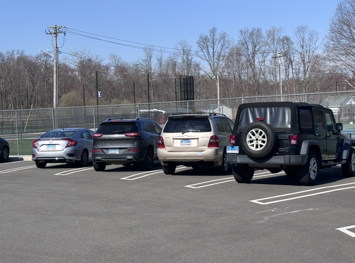 Four cars that belong to students parked in front of the tennis court. May 1, 2026. Photo courtesy: Michael D’Aiuto